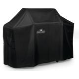 Black Napoleon 61500 fitted cover on a cart grill, seen at an angle, with a buckled strap at the side