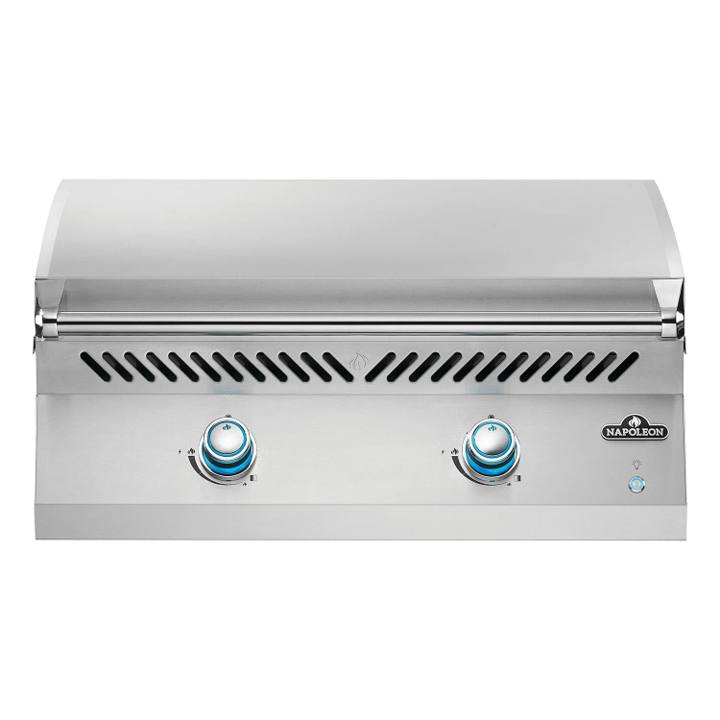 Napoleon Built-in 700 Series 32 griddle head, stainless lid down, two blue lit control knobs on the front panel
