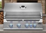 Napoleon Built-in 700 Series 32 stainless grill head with the lid closed and five blue lit control knobs