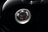Close view of the NK22 lid gauge, a stainless ringed dial with marked smoking and searing bands on the black lid