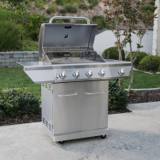 Nexgrill 720-0830H on a patio with the lid raised, warming rack above the grates and the side burner lid shut