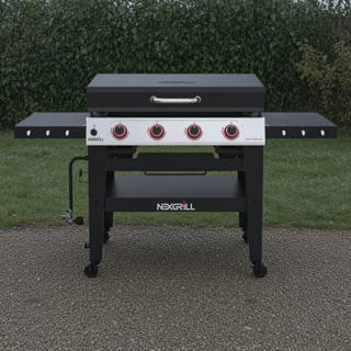 Nexgrill Daytona 4-burner griddle on wet gravel, lid closed, four red knobs on a stainless panel between black shelves
