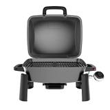 Nexgrill Fortress 1-Burner seen head on with the lid open, showing the cast iron cooking grid and the end carry handles