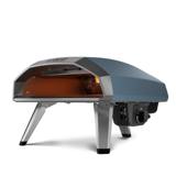 Ooni Koda 2 gas pizza oven in green, three-quarter view, with a pizza baking on the stone