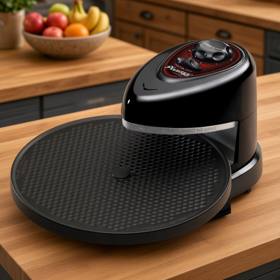 Presto Pizzazz Plus with its empty rotating tray on a butcher block kitchen island
