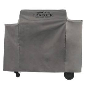Gray Traeger full-length cover with a black logo over an Ironwood 885 pellet grill, wheels showing below the hem