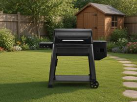Black Traeger Westwood XL pellet grill on a mown lawn, lid closed, wooden fence and a shed behind