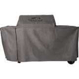 Gray Traeger full-length cover on a large Woodridge pellet grill, mountain logo on the hood, wheels under the hem