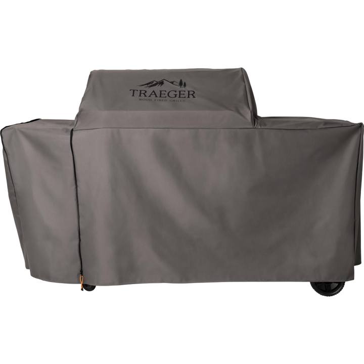 Gray Traeger full-length cover on a large Woodridge pellet grill, mountain logo on the hood, wheels under the hem