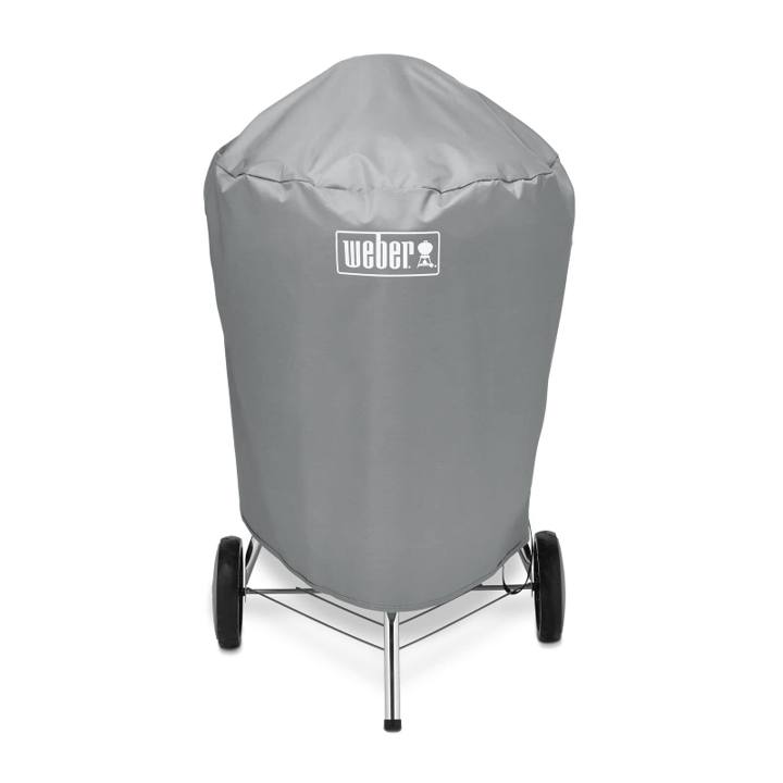 Gray Weber 7176 cover fitted over a 22 inch kettle, legs and wheels showing below the hem