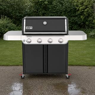 Weber Genesis E-415 four-burner propane grill, black lid beaded with rain, parked on wet gravel