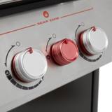 Close-up of the Genesis E-435 control panel, red Sear Zone knob between two silver burner knobs