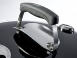 Close-up of the Master-Touch lid handle with its steel heat shield and the lid thermometer beside it