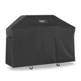 Black Weber Premium Grill Cover over a three-burner Genesis cart, side strap visible, casters showing below the hem