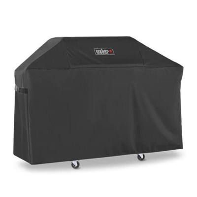 Black Weber Premium Grill Cover over a three-burner Genesis cart, side strap visible, casters showing below the hem