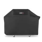 Weber Premium Grill Cover from the left front, Weber badge on the top panel, hem ending above two casters