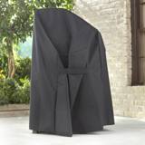 Weber Premium Grill Cover seen from the side on a stone patio, strap across the side panel, brick wall behind
