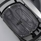 Weber Q 2400 seen from above with the lid open, showing the porcelain-enamelled cast iron cooking grates