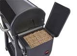 Open pellet hopper on the Weber Searwood XL 600, filled with hardwood pellets, its lid propped upright