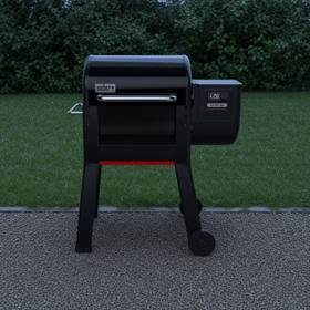 Weber Smoque pellet smoker on gravel beside a lawn, lid closed, side hopper and LCD controller to the right