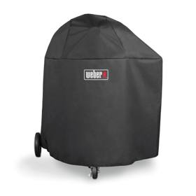 Black Weber cover with a logo patch pulled over a Summit kamado, two wheels and a front caster showing below the hem