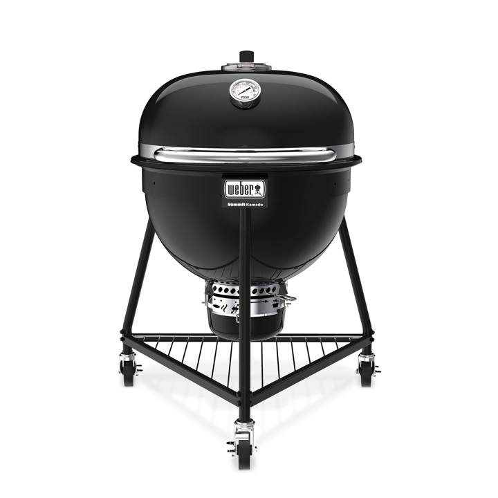 Weber Summit Kamado E6 in black, lid closed, on its three-caster tripod stand with a wire bottom rack