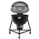 Weber Summit Kamado E6 with the lid hinged open, showing the insulated lid underside and round cooking grate