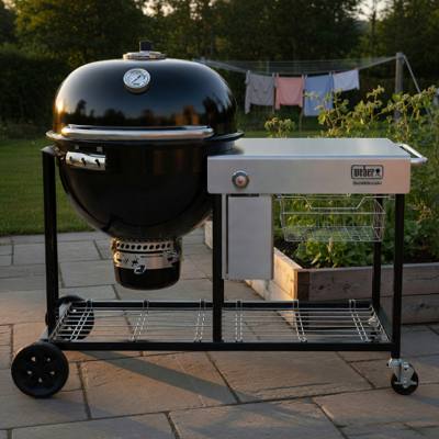 Weber Summit Kamado S6: black kamado bowl at one end of a black cart, stainless worktop filling the rest