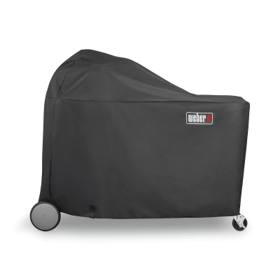 Black Weber 7174 cover over a Summit Kamado grill center, domed at one end, wheel and caster showing below
