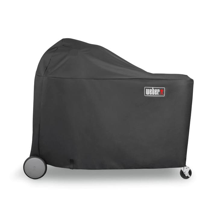 Black Weber 7174 cover over a Summit Kamado grill center, domed at one end, wheel and caster showing below