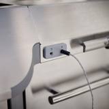 Detail of two numbered food probe ports on the side of the cook box, one holding a plugged-in wired probe