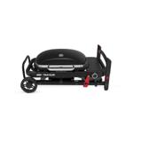 Weber Traveler Compact folded flat for transport, legs collapsed against the frame and lid locked, on white