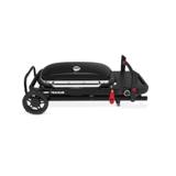 Weber Traveler folded flat for transport, legs collapsed against the frame and lid locked shut, on white