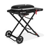 Three-quarter view of the Weber Traveler standing open on its folding legs with the side table extended